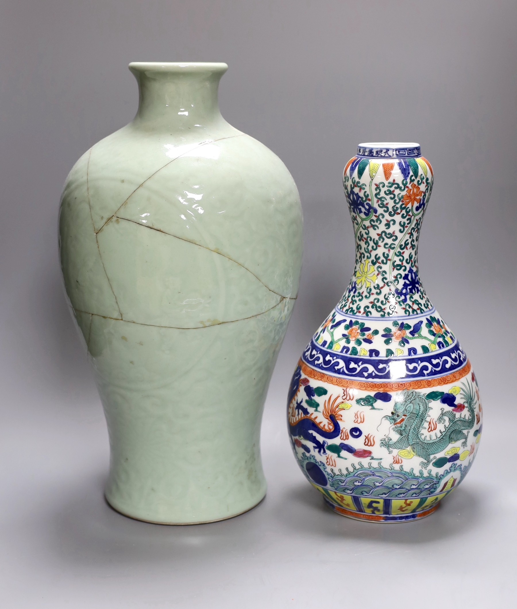 A large Chinese slip decoration celadon vase, together with another dragon vase, tallest 40cm